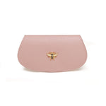 A pale pink glasses case with a textured vegan leather exterior and a honey bee charm on the front.