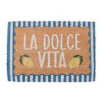 A rectangular coir doormat with a tan center panel reading 'LA DOLCE VITA' in white letters, decorated with two small lemon illustrations, and a blue-and-white striped border.