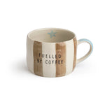 Striped stoneware mug with 'Fueled by Coffee' text.