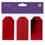 Red Christmas gift tags with glittery texture on a 'Christmas by Violet' branded packaging.