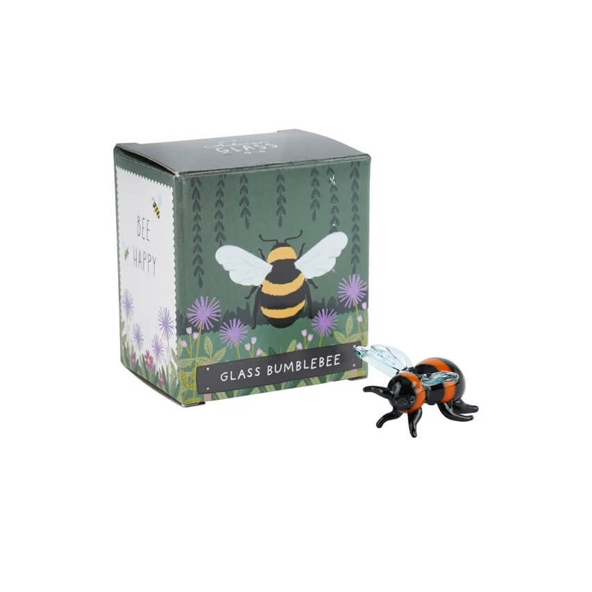 Artisan glass bumblebee figurine in front of its packaging box with bee design