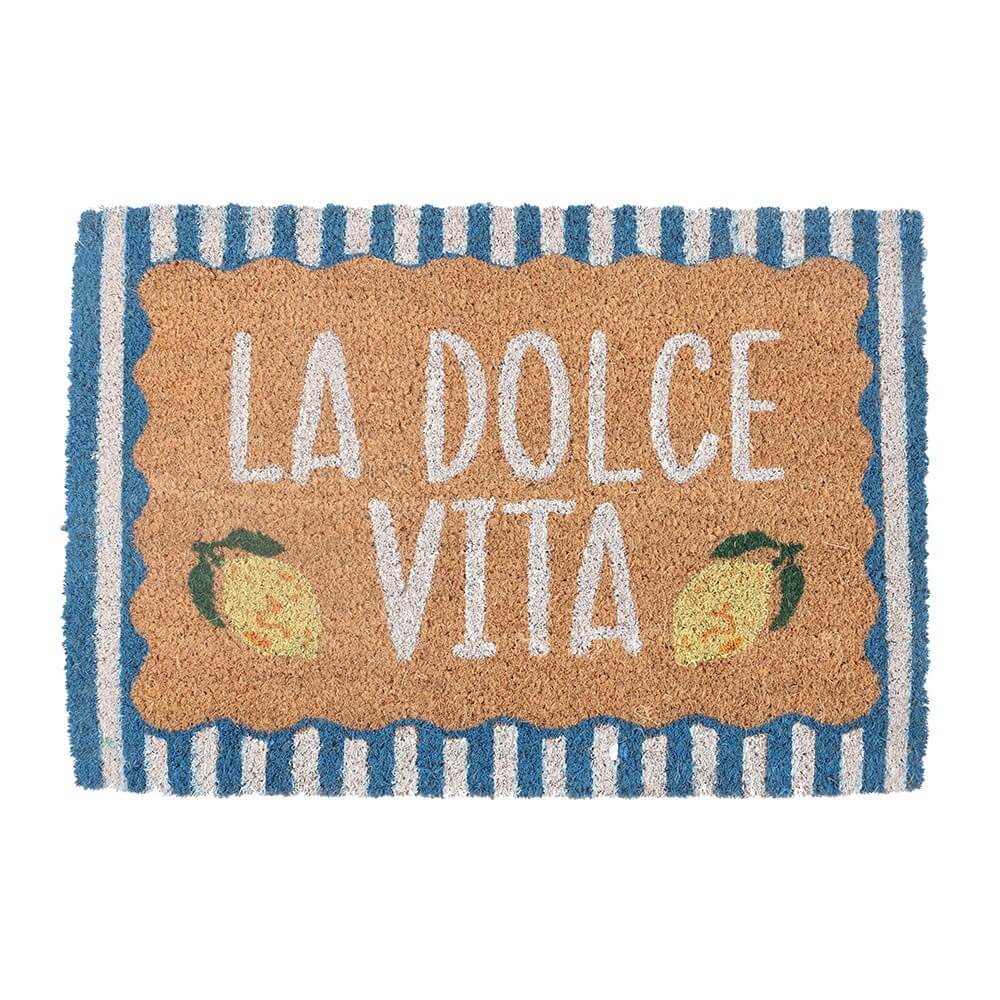 A rectangular coir doormat with a tan center panel reading 'LA DOLCE VITA' in white letters, decorated with two small lemon illustrations, and a blue-and-white striped border.