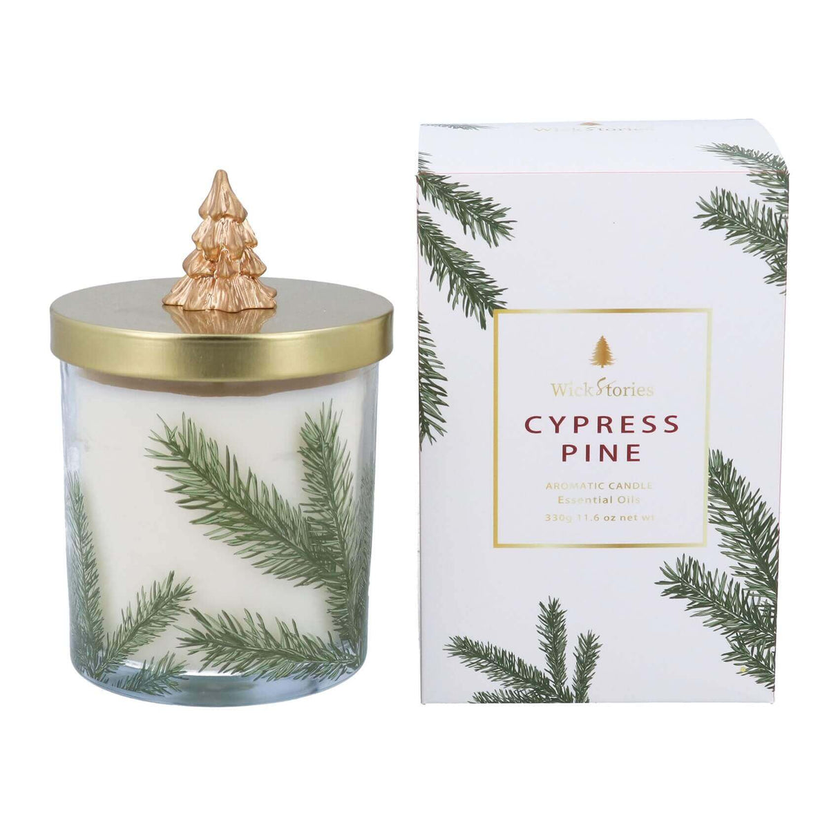A Gisela Graham Cypress Pine scented candle in glass jar with green pine branch illustrations, featuring a gold lid with gold Christmas tree topper, shown next to its white gift box packaging, decorated with pine branches.
