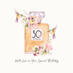 A watercolor-style birthday card design featuring a perfume bottle with a 30th birthday label, decorated with pink flowers and two hummingbirds, with the text 'With Love on Your Special Birthday'