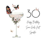 A 30th birthday card design featuring a champagne coupe glass decorated with a butterfly, flowers, and glitter, alongside the text '30 Happy Birthday Same Girls Just Sparkle!'.