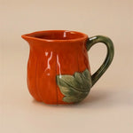Ceramic pumpkin mug with a green leaf and handle for Halloween