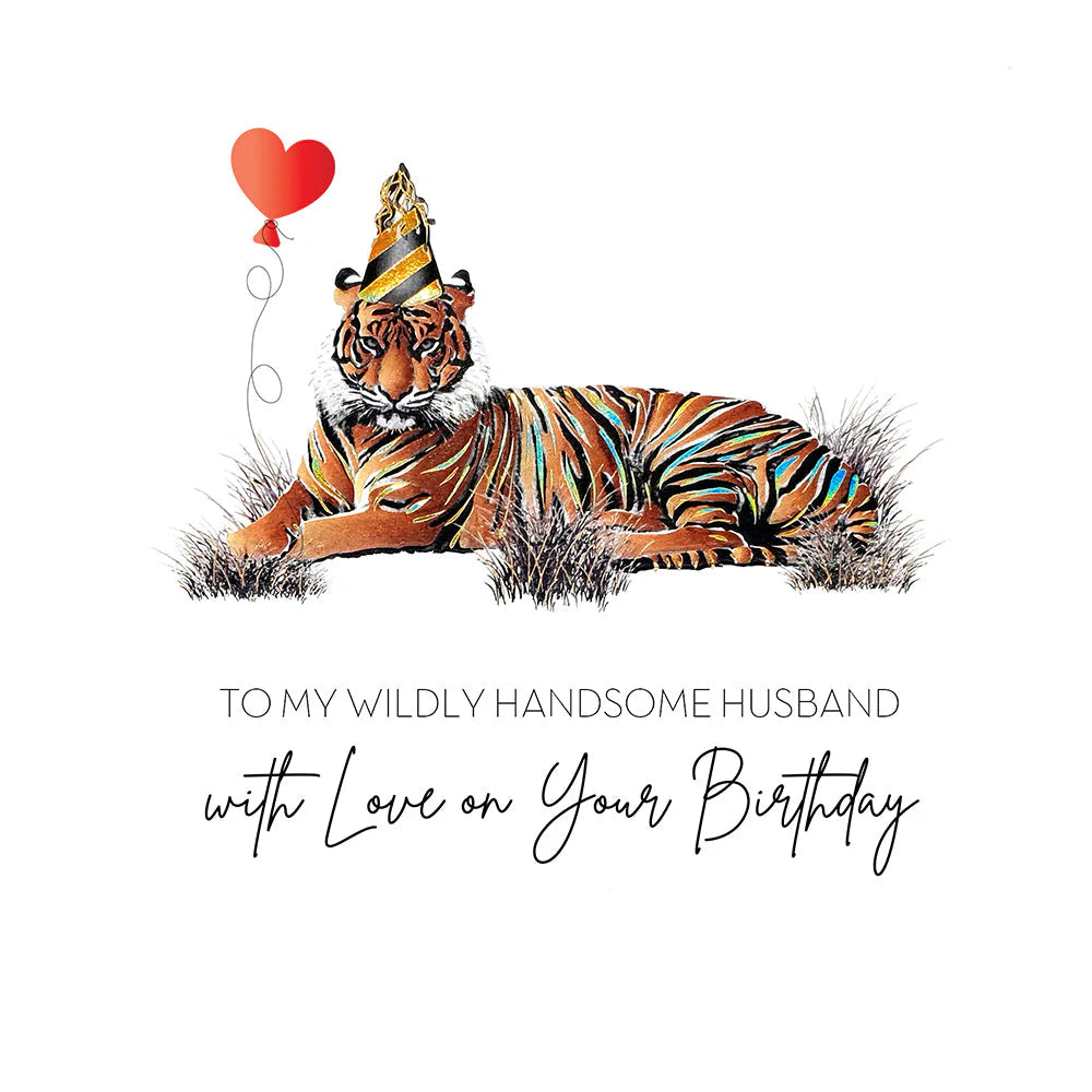 A Five Dollar birthday card design featuring a tiger lying in grass with a red heart-shaped balloon and a party hat, above the text 'TO MY WILDLY HANDSOME HUSBAND with Love on Your Birthday' .
