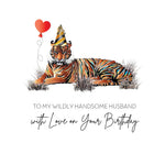A Five Dollar birthday card design featuring a tiger lying in grass with a red heart-shaped balloon and a party hat, above the text 'TO MY WILDLY HANDSOME HUSBAND with Love on Your Birthday' .